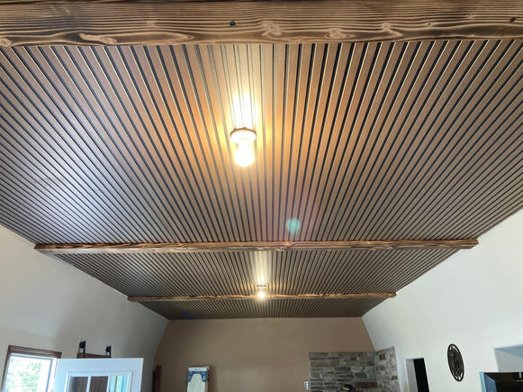 Installed new ceiling panels, burned and installed decorative ceiling beams
